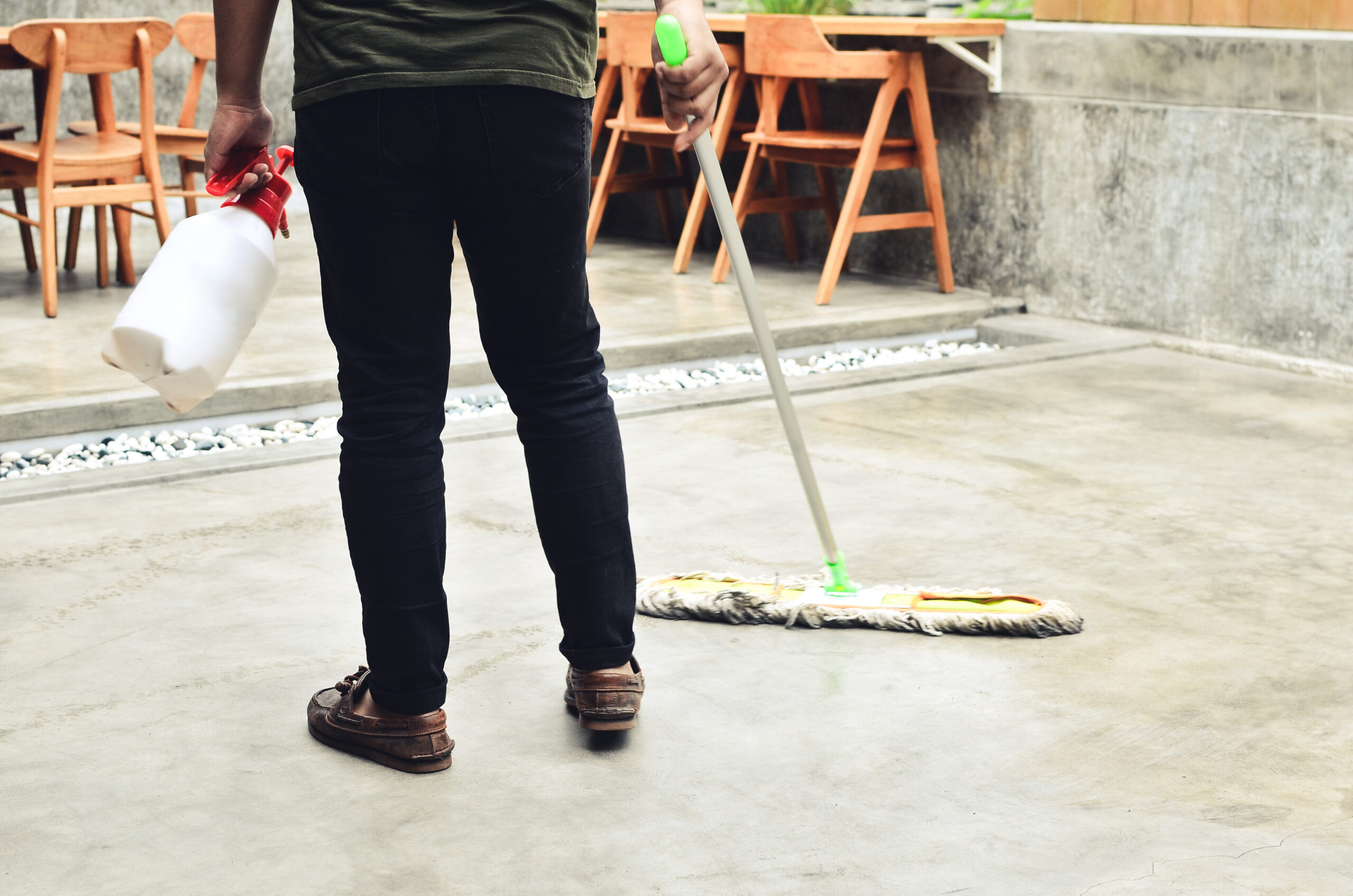 young man mopping the coffee shop floor